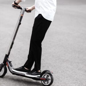 This image is being used as the main image for our article on Electric Scooters. It shows a man riding an electric scooter.